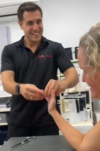 Gold Coast Hand Therapy OT, Nick Criticos treating patient and smiling